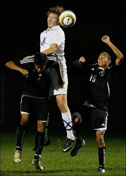  - District-Boys-soccer-leaping