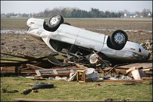 An overturned car in the field behind the home of Jerry and Myrna Montri on Ida Center Rd. in Ida Township,MI. The  Monroe, MI  area was hit by large storms, hail and a tornado last year.