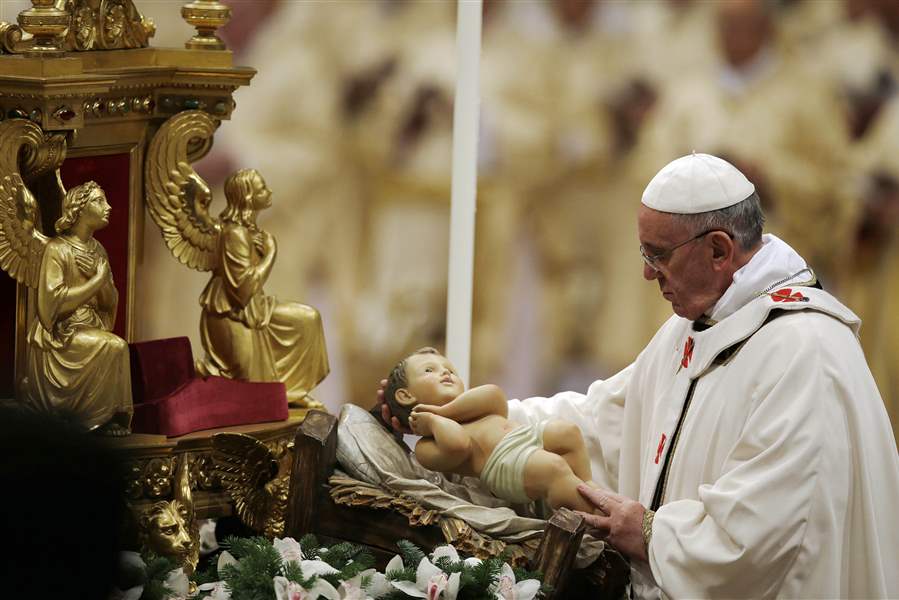 Francis cradles a baby Jesus statue at start of his first papal