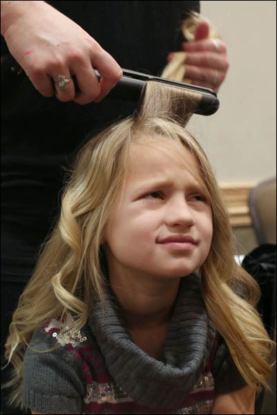 <b>Anna Guzzo</b>, 6, is less than thrilled with the process of having her hair - WEBpbg-tea29-6