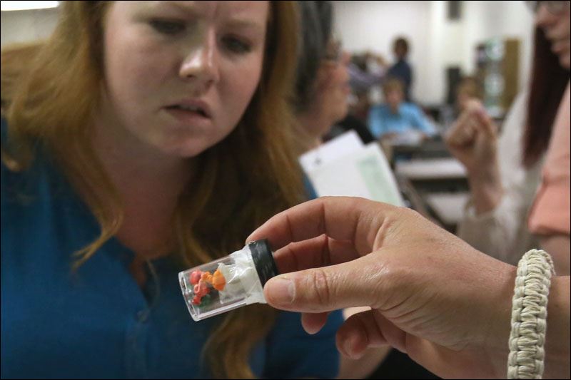 Lt. Shawn Bain holds a vile of heroin balloons out for a seminar attendee after - WebSylDRUGS22p-vile-of-heroin-balloons