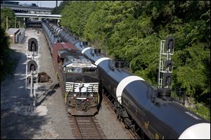 Empty and loaded oil trains pass each other just west of I-75 near downtown Toledo.