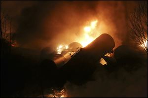 Derailed oil tanker train cars burn near Mount Carbon, W.Va. A CSX train carrying more than 100 tankers of crude oil derailed in February during a snowstorm, sending a fireball into the sky and threatening the water supply of nearby residents.