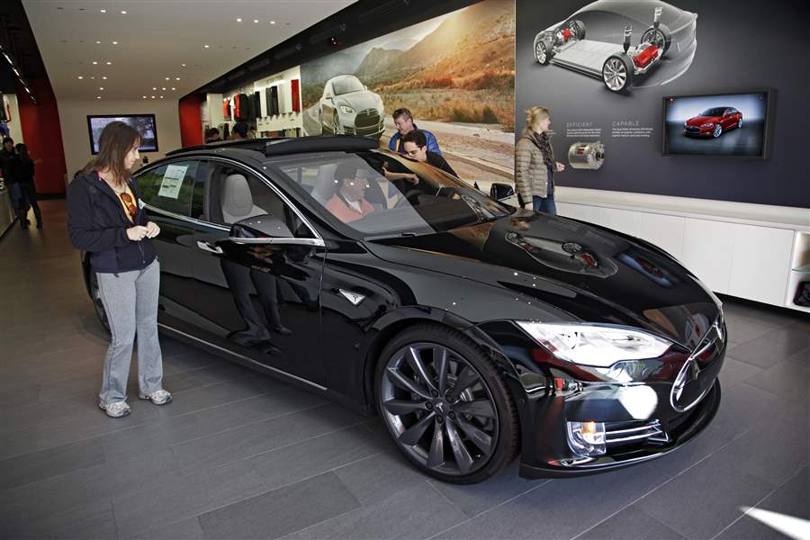 Tesla sues Michigan, challenges law requiring dealer sales
