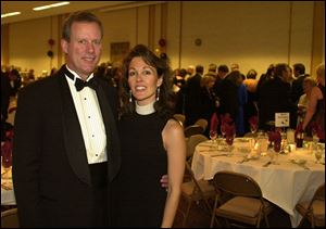 Honorary chairmen of the Mobile Meals Gala, Jim and Kristie Hoffman, pause at Stranahan Great Hall.