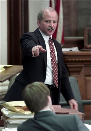 Hancock County Prosecutor Robert Fry points to Graham, in foreground, at left, as the leader in the attack on a 13-year-old girl Feb. 12, 1999.