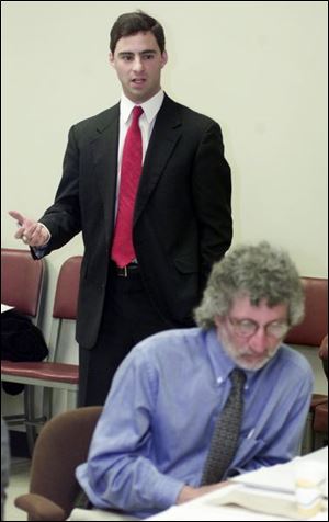 Andrew Schuman encourages a Lucas County ban on smoking in public places. In foreground is Dr. David Grossman, Toledo-Lucas County health commissioner.