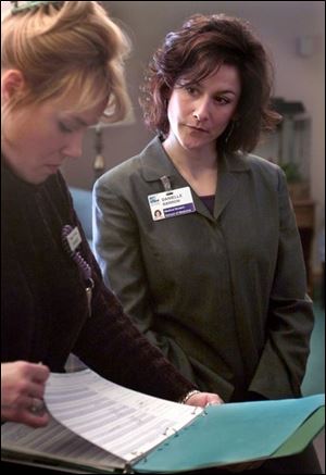 Student Danielle Barrow listens to registered nurse Diane Smith's comments about patients.