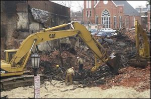 Firefighters from 12 departments battled the blaze in the building that housed the teen center, now being torn down in Tiffin.