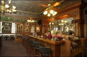 Vintage light fixtures and bar, as well as a pressed-metal ceiling, attest to the Island House's Age.