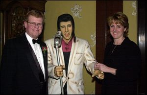 LOVE ME TENDER: Chairman Jeff Gibbs and Susan Gibbs with a statue of The King at the Inverness Club.