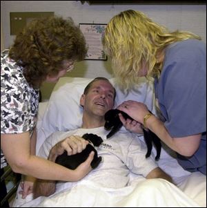 Waldron, Mich., school Superintendent David Anspaugh experiences pet therapy in a nursing home. His Chevrolet hit a wall at a track on Aug. 26.