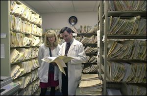 Dr. Kenneth Bertka and office manager Pam Carter say accessing medical records can be facilitated by placing the information on a database, a move promoted by an area health alliance.
 
 
 THE BLADE/JEREMY WADSWORTH
 Dr. Duane Gainesburg, left, wants medical records placed on a database, using a plan by David Chatfield, right, president of Community Health Alliance of Northwest Ohio.