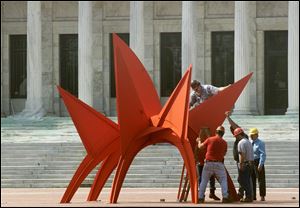 A crew installs Alexander Calder's “Stegosaurus” in the sculpture garden at the Toledo Museum of Art.