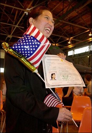 Mei Lan Thallman of Tiffin shows off her citizenship. Her husband is in Ms. Thallman's native Taiwan.