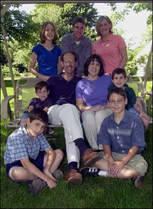 Dave and Karla Tracey share their glider with sons Daniel, 4, and Andrew, 7. In the back row, from left, are Noelle, 15, Chris, 18, and Katie, 20. In the front row are Aaron, 9, and Ben, 11.