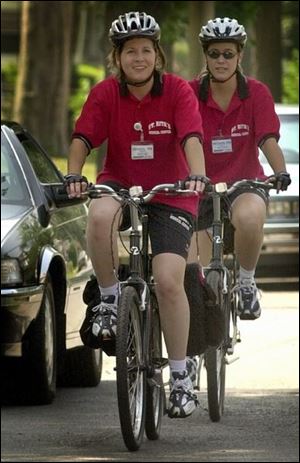 Denise Barnes, left, and Megan Bailey head down Nye Street in Lima on their way to a visit.