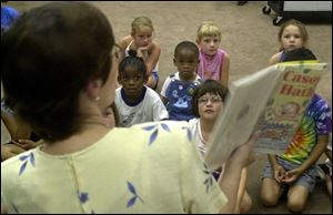 Children's librarian Sue Schaefer reads Casey and the Bath as part of the Reynolds Corners branch library's Bubble Odyssey.