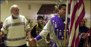 Dennis Bibee, left, of Maumee, participates in a friendship dance with Brian Diggs.