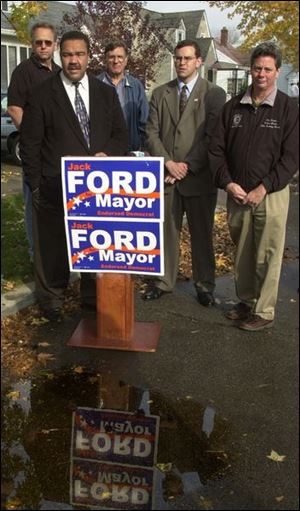 Jack Ford holds a news conference in front of the home of Kyle and Diana Schnitkey on Cloverdale Road to discuss Toledo's street repaving needs.