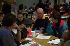 Bob Clark makes a point at Start High School during a small group discussion that was part of the first of a series of forums to gather opinions on district construction issues.