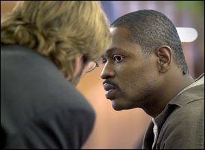 Wesley Ulis of Toledo, who is serving life sentences for two 1988 slayings, talks with his court-appointed attorney, David Klucas, left, before entering his plea in another case.