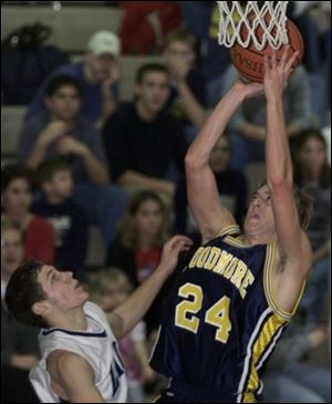 Woodmore's Justin Perkins goes up for a shot as Lake's Wes Blank defends.