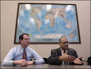 Lee Springer, left, and Vinod Jain, at the Regional Growth Partnership headquarters, work toward increasing the area's trade with the world.