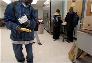 Youngsters leave with breakfast from the Kitchen for the Poor in Toledo's central city.