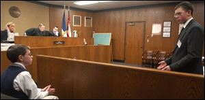 Jeremy Smith, right, of Archbold cross-examines Kyle Ducey during a mock trial at Toledo Municipal Court. The trial was part of the Ohio Mock Trial competition.