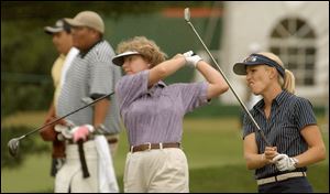 Suzanne Strudwig, left, and Carrie Koch use the practice tees yesterday morning. Players will hit off the Nos. 1 and 10 tees at 7:30 a.m.-9:20 a.m. and noon-1:50 p.m. in tomorrow's first round.