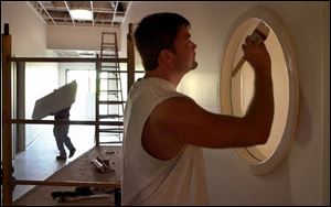 Mark Zorbaleeff puts some final touches on the Head Start center, scheduled to open next month.