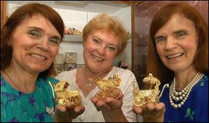 `I've known these girls since they first started collecting,' says Rossford resident Judy Sikorski, with Judith Roach Kaminski, left, Janet Roach Pallo, right, and their carriages.