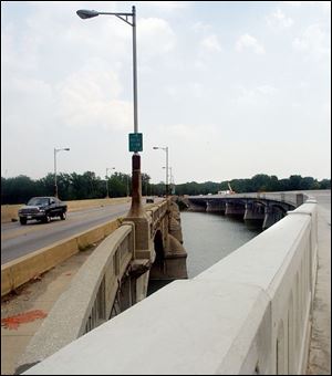 Traffic heads across the Maumee-Perrysburg bridge, at left, which will be replaced by the new span, at right, by Nov. 1.