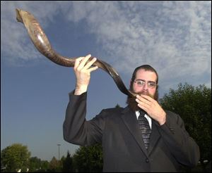 Rabbi Shmuly Rothman of Chabad House-Lubavitch demonstrates the sounding of the shofar, which signals the beginning of the High Holy Days.