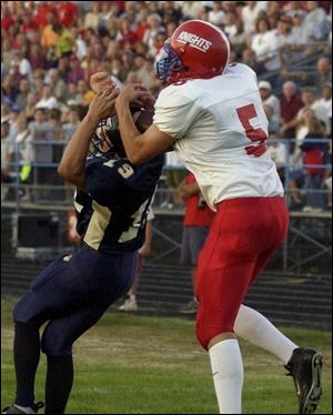 Whitmer's Chad Sharp (19) can't keep St. Francis receiver Chad Lewandowski, who made four catches for 97 yards, from making a touchdown catch during the first quarter last night at Whitmer.