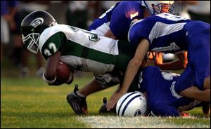 Start's Allen Drake is brought down by three Anthony Wayne defenders in last night's game at Anthony Wayne. The Generals led 12-7 at halftime. The Spartans scored 22 unanswered points in the second half for the victory.