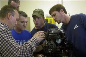 Instructor Tim Baker, left, assists Darrel Roberson, Chad Thompson, and Trent Sattler.