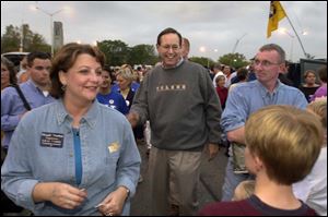 Maggie Thurber has Gov. Bob Taft to help her work the crowd at the tailgate party before the UT football game.