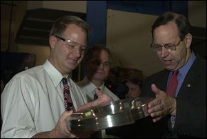 Eric Fankhauser, left, and Craig Fankhauser of Toledo Metal Spinning show Ohio Gov. Bob Taft their Clinton Street firm's handiwork.