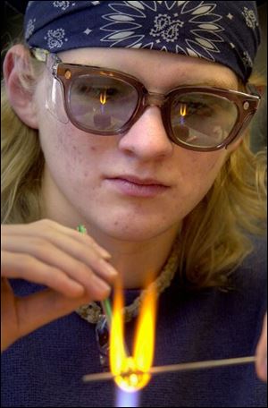 Jon Zapiecki, 17, of Toledo, works on a new creation in his glass bead-making class at the Toledo Museum of Art.