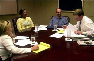 Teri and Matthew McGinnis, center, discuss their situation with their advisers.