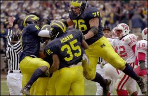 Jason Avant, left, B.J. Askew and Dave Petruziello mob Braylon Edwards after he scored winning TD for Michigan.