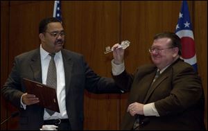 Mayor Jack Ford presents Peter Ujvagi with a key to the city during Mr. Ujvagi's last meeting as president of council.