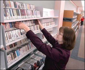 Carol Dunn, audio-visual manager, arranges audio cassettes to be sold for a quarter apiece as the Findlay-Hancock County Public Library gets rid of them.