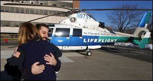 Andre Stolar gives Life Flight nurse Julie Goins a hug for saving his life after he was involved in an accident in September.