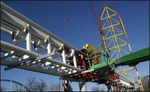 Craig Athers, left, and Mike Manhart with the Cedar Point ride-maintenance division work on the new roller coaster. Scheduled to open in May, the Top Thrill Dragster will be the tallest and fastest in the world. 