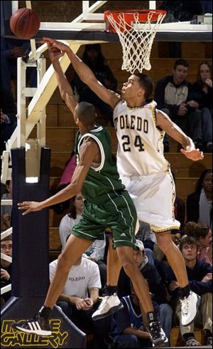 Toledo's Sammy Villegas (24) blocks a shot by Eastern Michigan's Markus Austin. The Rockets lost for the fifth time in the last six games and their record fell to 10-14 overall and 4-10 in the MAC.