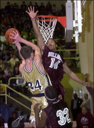 Scott's Vershawn Chears tries to block a shot by St. John's Zach Hillesland in the sectional final last night at Libbey.