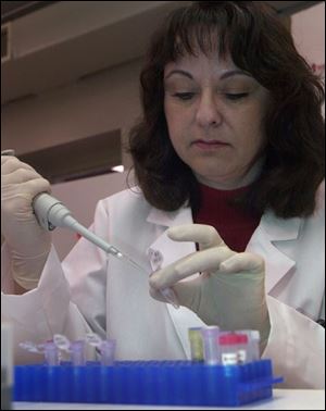 Myrna Graham works with DNA at Gene Express lab.